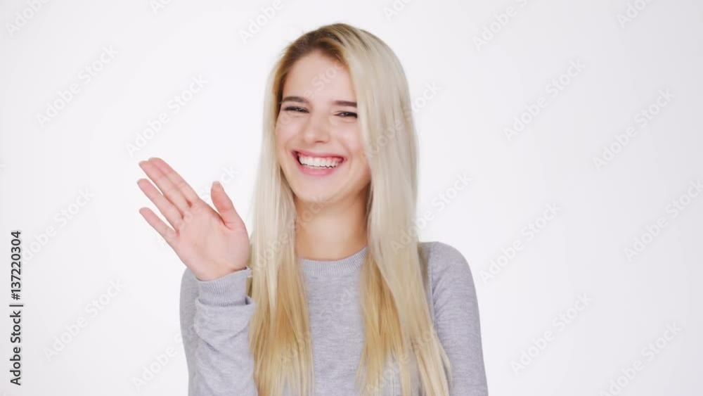 Young Woman in gray sweater pointing at camera and after showing no gesture Young Woman in gray sweater pointing at camera and after showing no gesture
