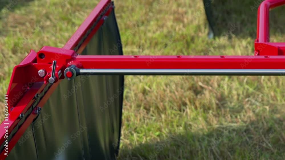 The side of the agricultural machinery extends and then it closes back again. It is used for protection hay from flying everywhere around when a farmer is using rotary rakes.
The side of the agricultural machinery extends and then it closes back again. It is used for protection hay from flying everywhere around when a farmer is using rotary rakes.