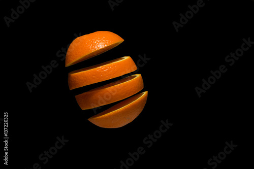 Orange, fruit levitation on black background