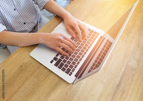 Woman office worker is typing keyboard of laptop, business or learning concept