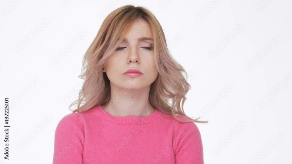 Woman in pink sweater offended and looks at camera Woman in pink sweater offended and looks at camera