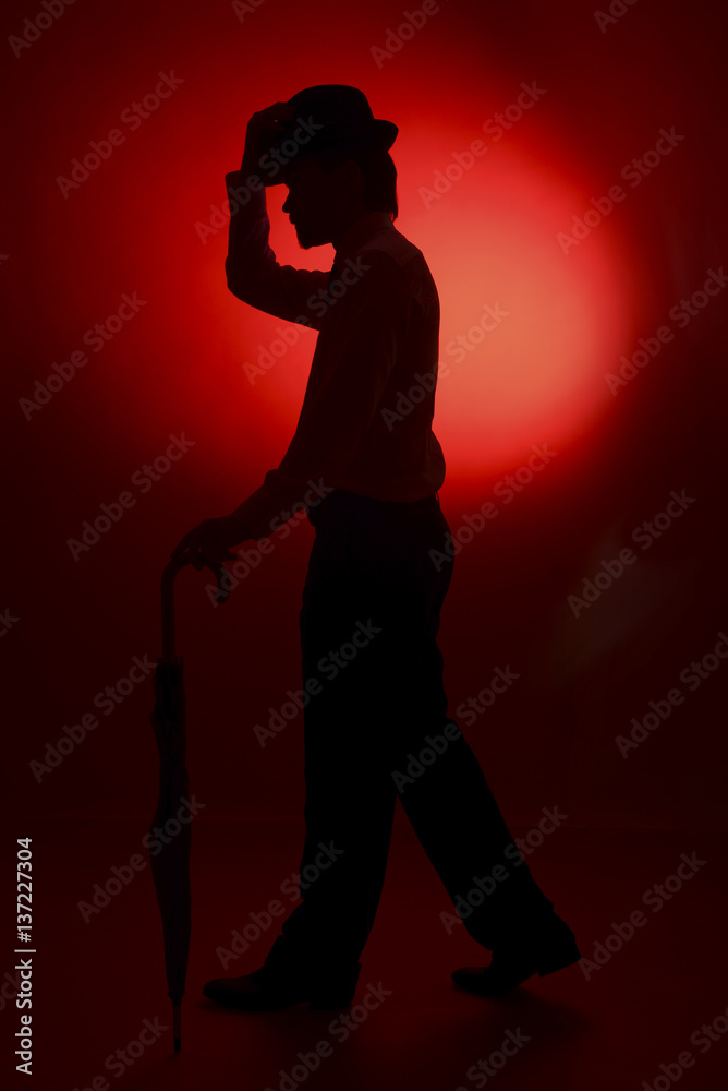 The silhouette of the bride and groom on a red background The silhouette of the bride and groom on a red background