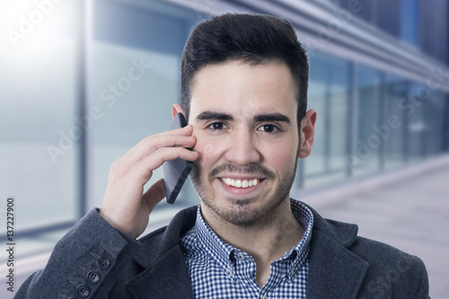 businessman smiling talking on mobile phone