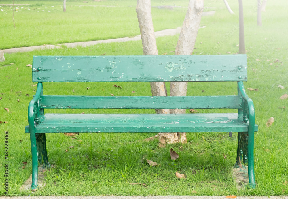 alone of old green bench in public park on sunshine day. alone of old green bench in public park on sunshine day.