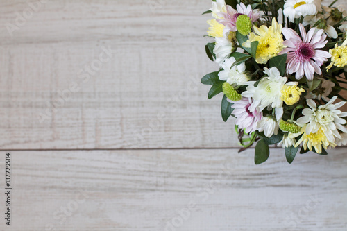 Bouquet of different chrysanthemums on wooden background. Aerial view. Copy space