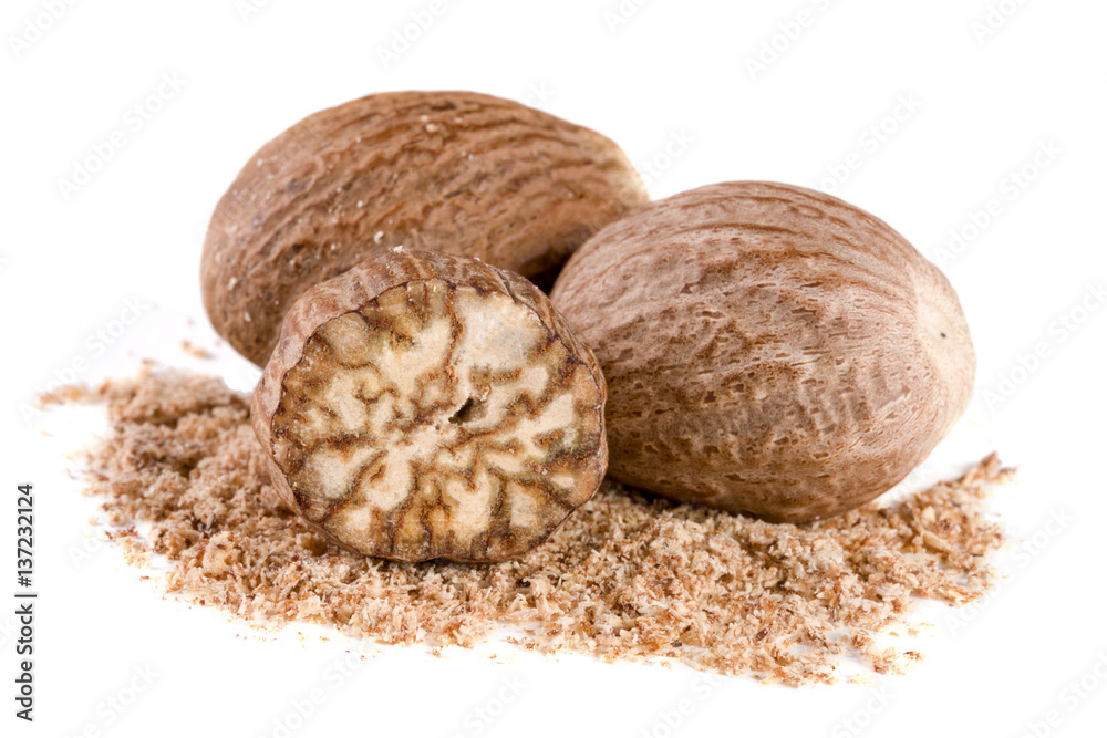 Three nutmeg and powder isolated on white background Three nutmeg and powder isolated on white background