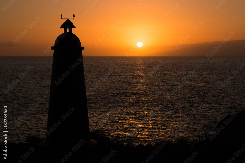 Lighthouse in silhouette at sunset in Tenerife