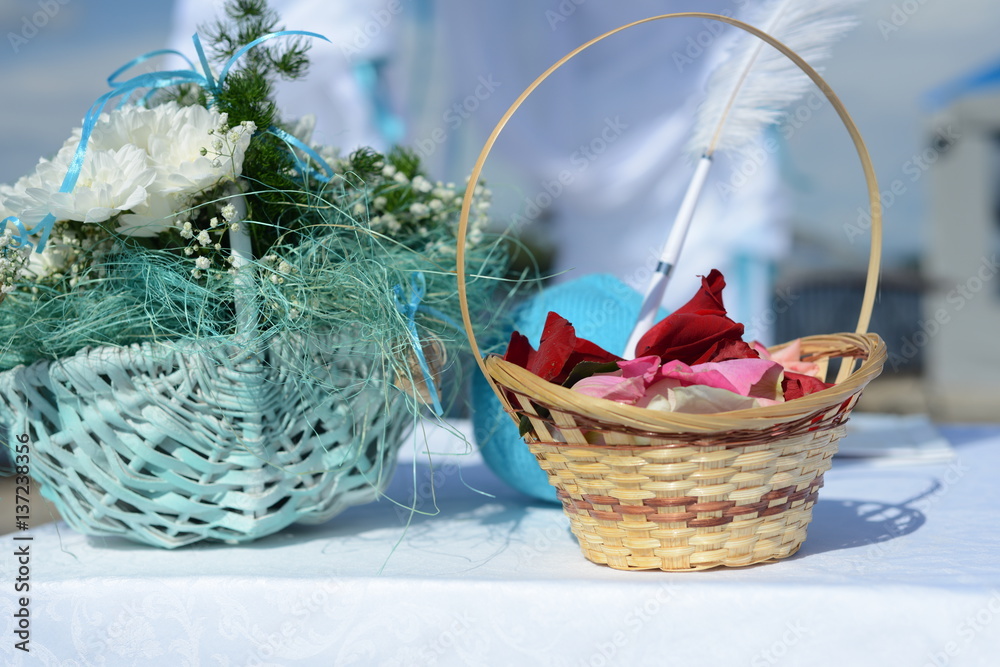 Wedding basket with rose petals and chrysanthemums