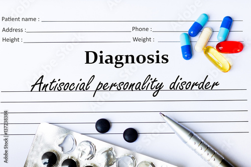 Antisocial personality disorder - Diagnosis written on a piece of white paper with medication and Pills