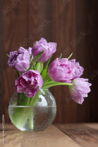 Wallpaper Mural Violet tulips in a round vase on a wooden background Torontodigital.ca
