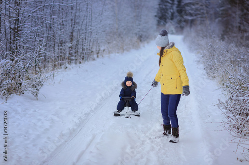 Little boy with mother outdoor. Winter. Sled.. © Natalia