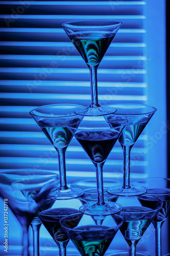 beautiful wine champagne glasse in front of colorful background with shades of blue.