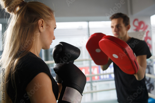 Young couple trains in boxing photo