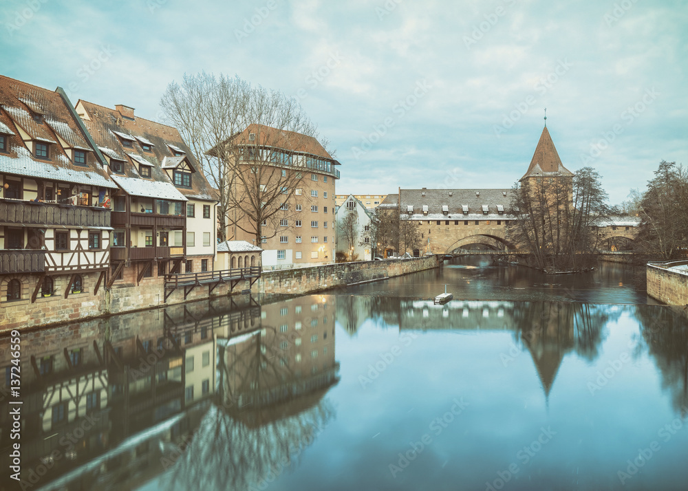 Winter landscape of fortification with a tower Fronveste Schlayerturm on Pegnitz river in Nuremberg, Bavaria, Germany