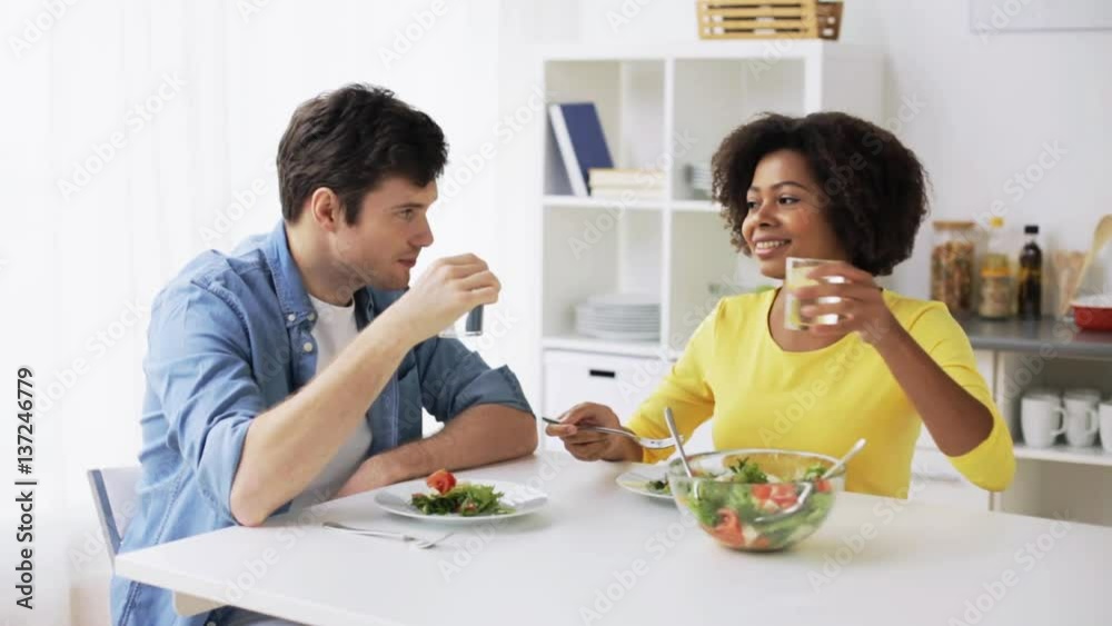 happy couple eating vegetable salad at home happy couple eating vegetable salad at home
