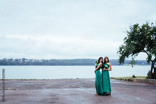 Happy young women at a wedding with bouquets of flowers