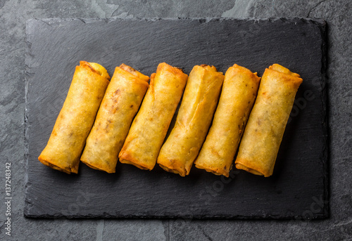 Fried spring rolls on slate plate. Top view