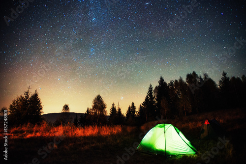 Camping under the stars. Green solo tent dark night sky