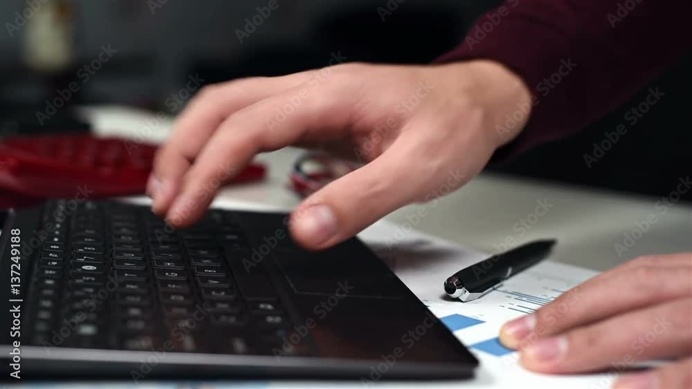 Trader Monitoring Stock Statistics And Financial Report on Laptop Trader Monitoring Stock Statistics And Financial Report on Laptop