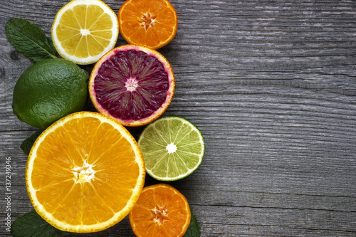 Fototapeta Naklejka Na Ścianę i Meble -  Lemon,red orange, orange, grapefruit,  lime on old wooden table. Background.