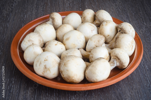 Fresh champignon mushrooms on plate