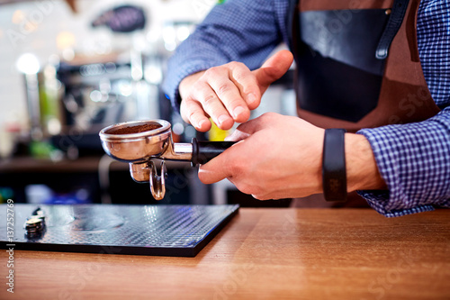 Hands bartender baristas make coffee cocoa cappuccino.