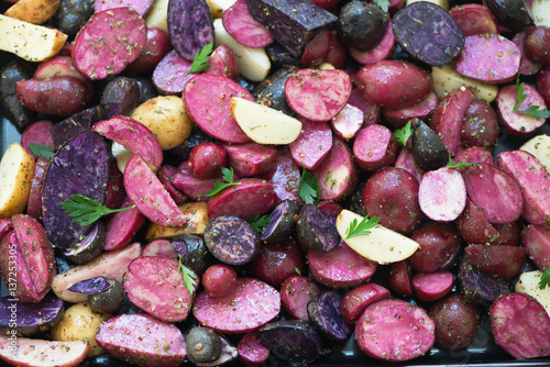 Close view of raw sliced purple and pink potatoes. 