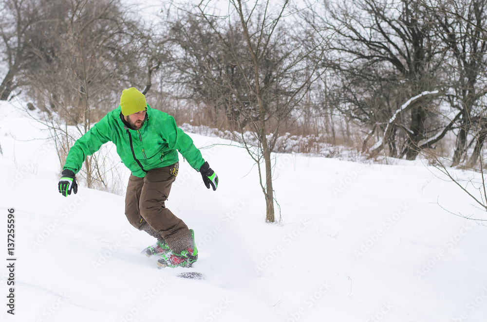 Active man snowboarding.