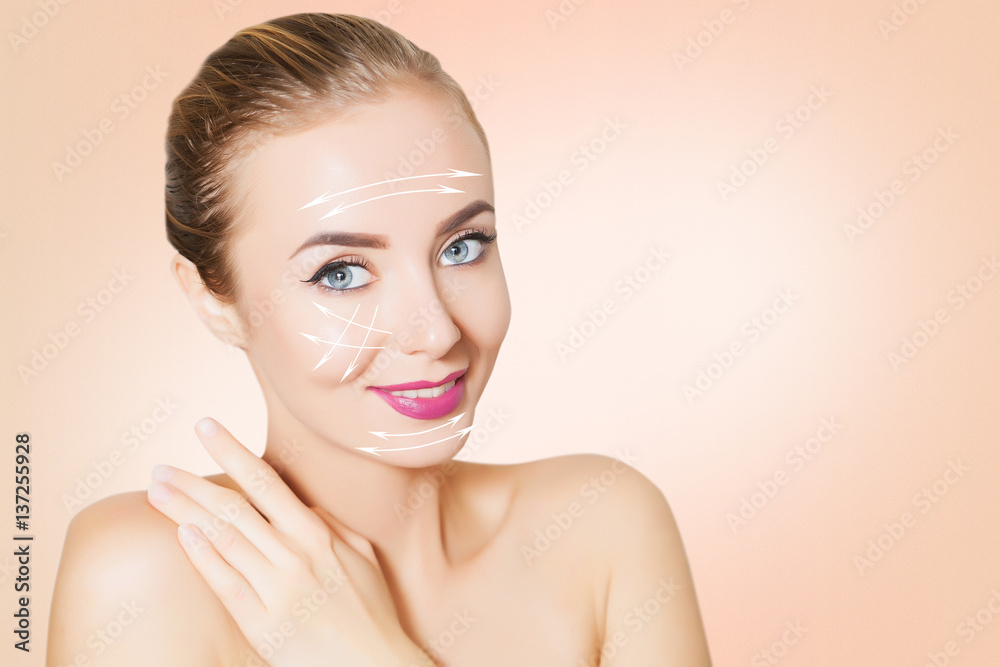 blonde Woman face with marks and arrows on pink blonde Woman face with marks and arrows on pink