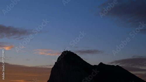 Sunrise time-lapse of the Rock of Gibraltar with morning cloudy sky, UK.
