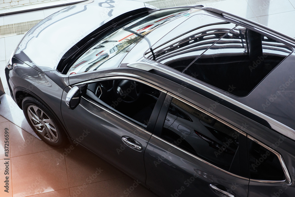 of the car in the spacious showroom with large windows of the car in the spacious showroom with large windows