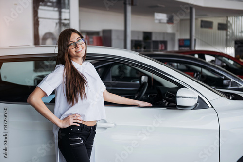 Pretty girl is standing near her car. © standret