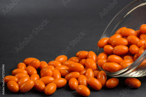 Gelatin softgels with coenzyme Q10, orange health capsules, healthy diet and beauty concept