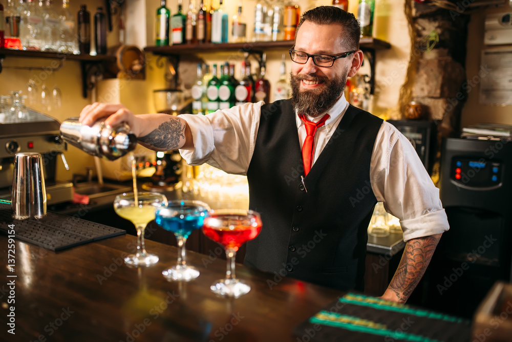 Bartender making alcohol beverages in nightclub