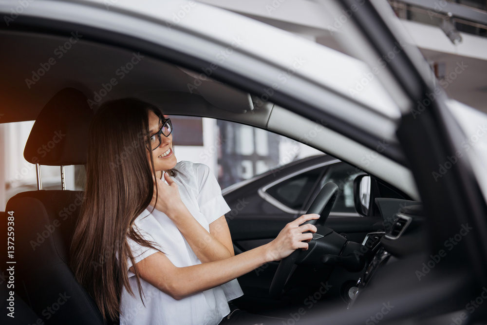 portrait of young beautiful woman sitting in the car