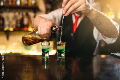 Barman making attractive alcoholic cocktail