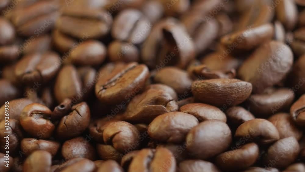 Roasted coffee beans on a table. Slow motion Rotating. Close up Roasted coffee beans on a table. Slow motion Rotating. Close up