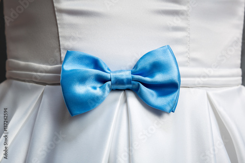 Blue bow on white wedding dress