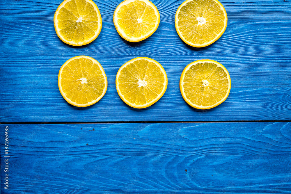 Cut orange fruits on blue wooden background top view mockup Cut orange fruits on blue wooden background top view mockup