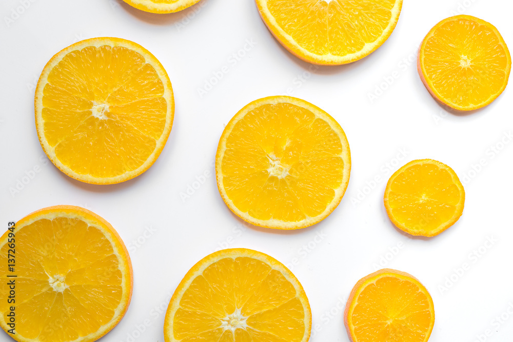 slices of oranges on white background bright pattern top view slices of oranges on white background bright pattern top view