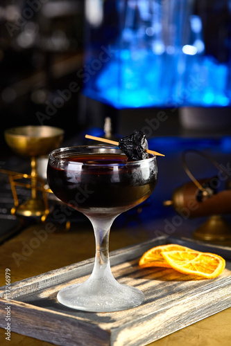 Fototapeta Naklejka Na Ścianę i Meble -  alcoholic cocktail with prunes and orange