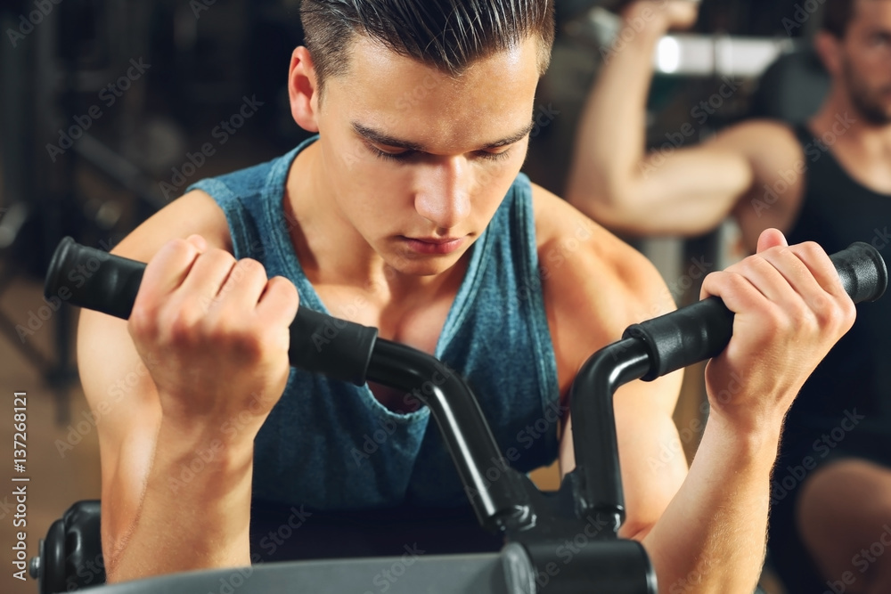Athletic man training in modern gym