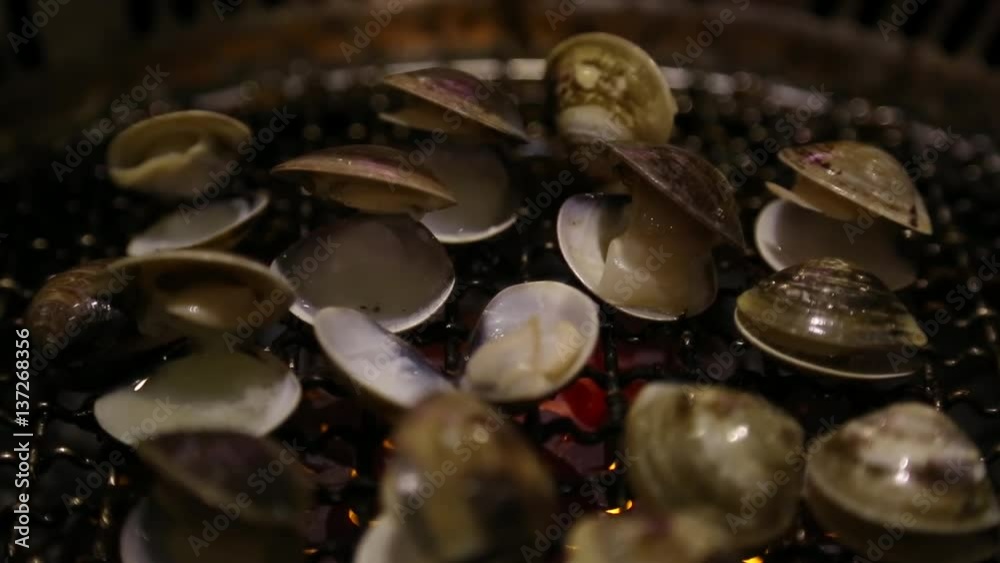 making delicious food BBQ chinese calms in Taiwan in one buffet restaurant propane gas grill a cooking grate and soft focus flames beneath -Dan making delicious food BBQ chinese calms in Taiwan in one buffet restaurant propane gas grill a cooking grate and soft focus flames beneath -Dan