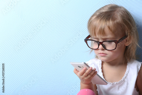 Cute little girl with glass...