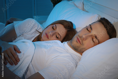 Young cute couple sleeping ...