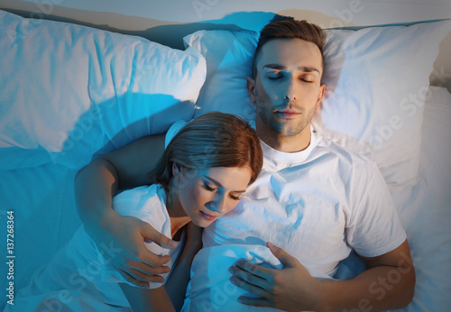 Young cute couple sleeping ...