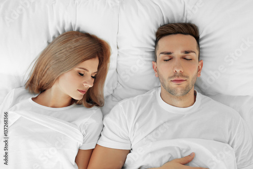 Young cute couple sleeping ...