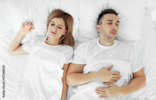 Young cute couple sleeping ...