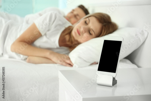 Happy couple waking up with...