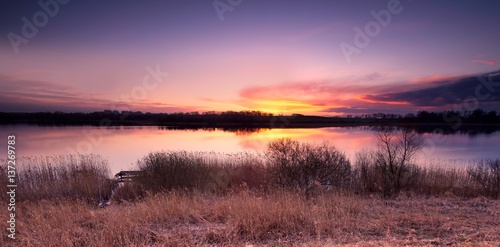 Beautiful sunset over spring lake landscape
